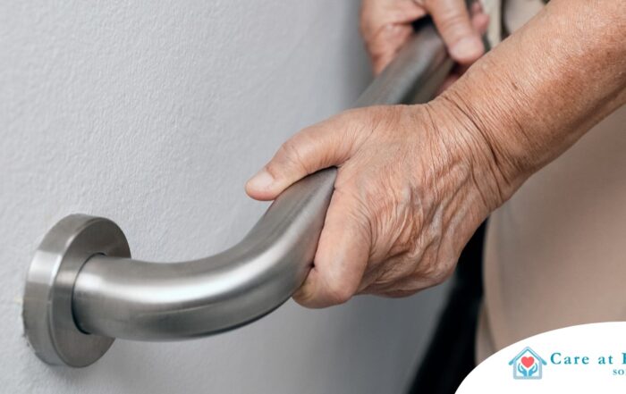 An older adult uses a grab bar representing one of the home modifications that is helpful for fall prevention for elderly adults.