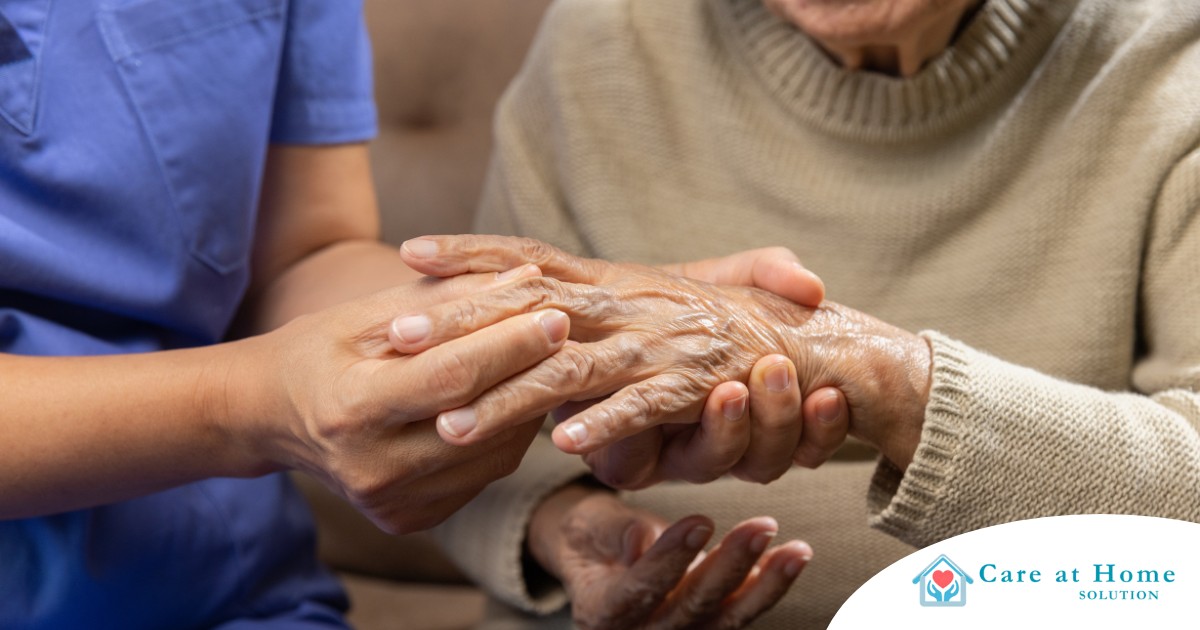 A care provider examines an older adult’s fingers, representing what would happen in an examination for rheumatoid arthritis.
