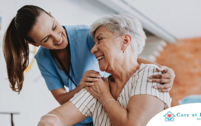 A female caregiver helping an older woman with stroke recovery at home.